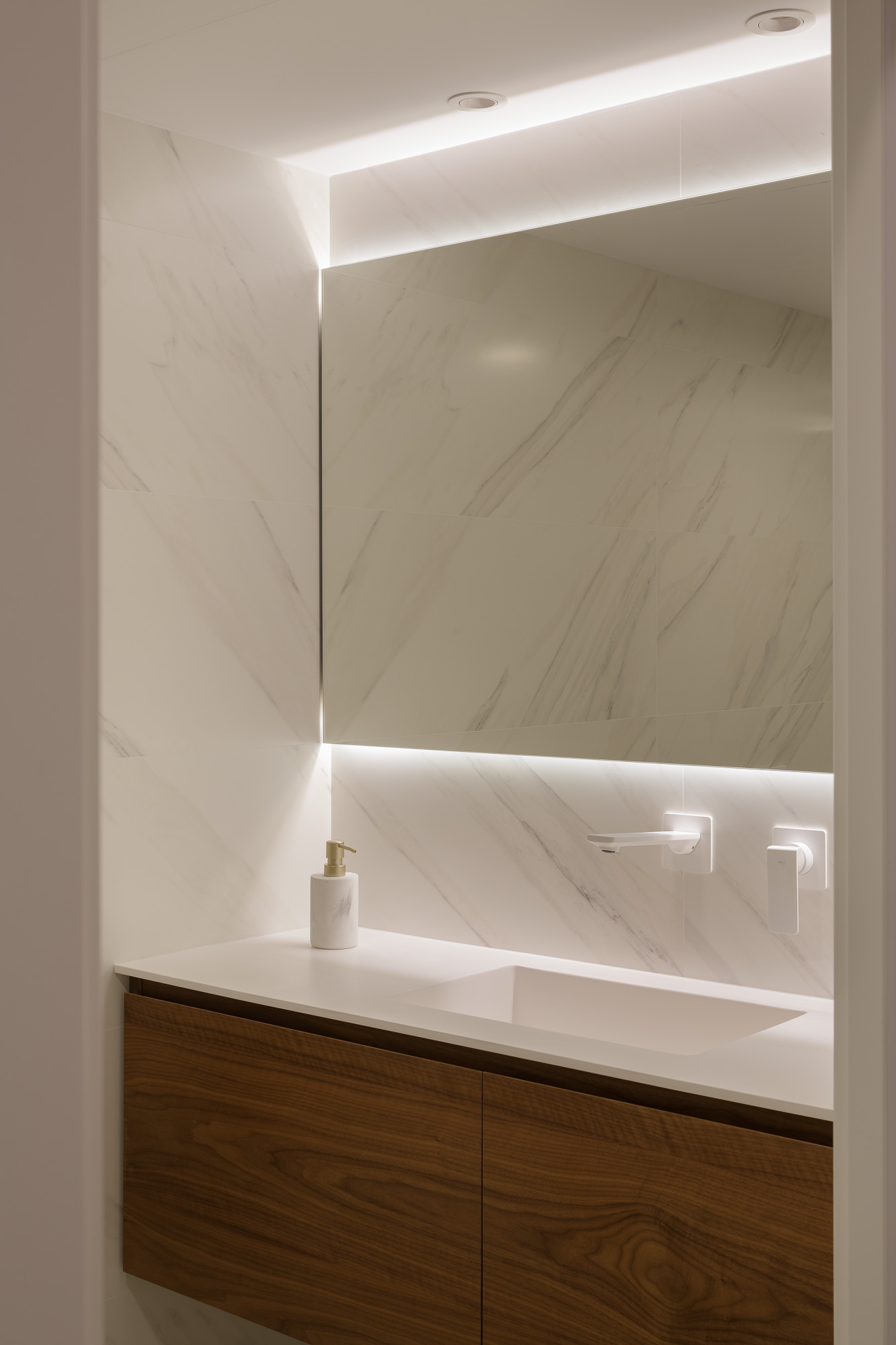 Baño con espejo iluminado led y mueble a medida